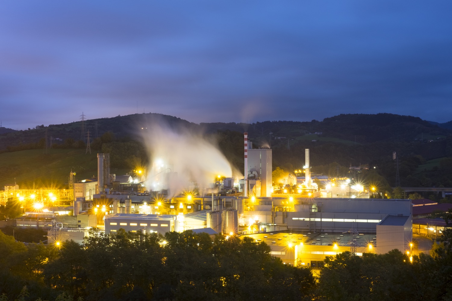 Panoramic view of a large factory at night. 